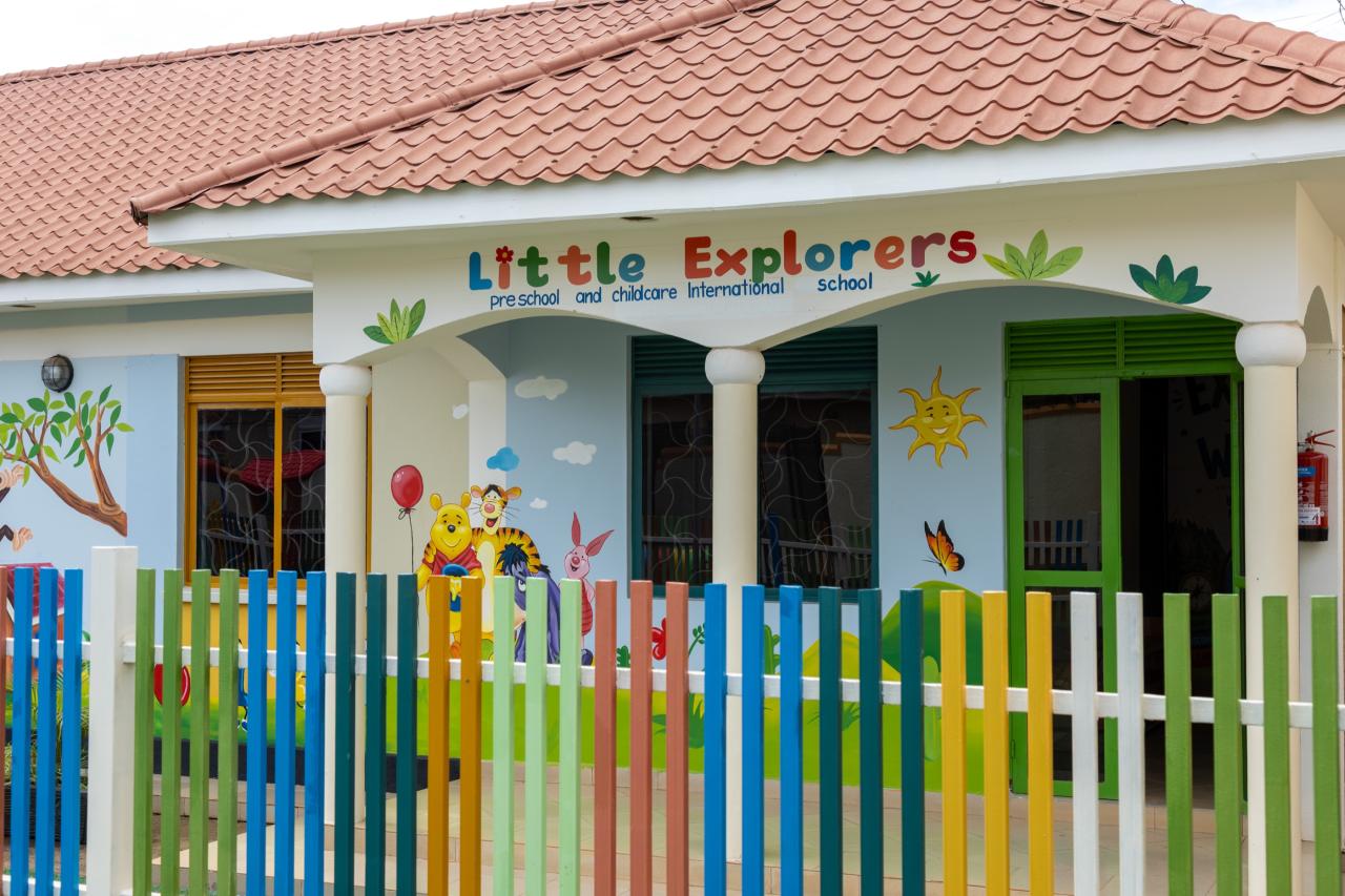 The front of Little Explorers with its painted sign, cartoon mural and rainbow fence