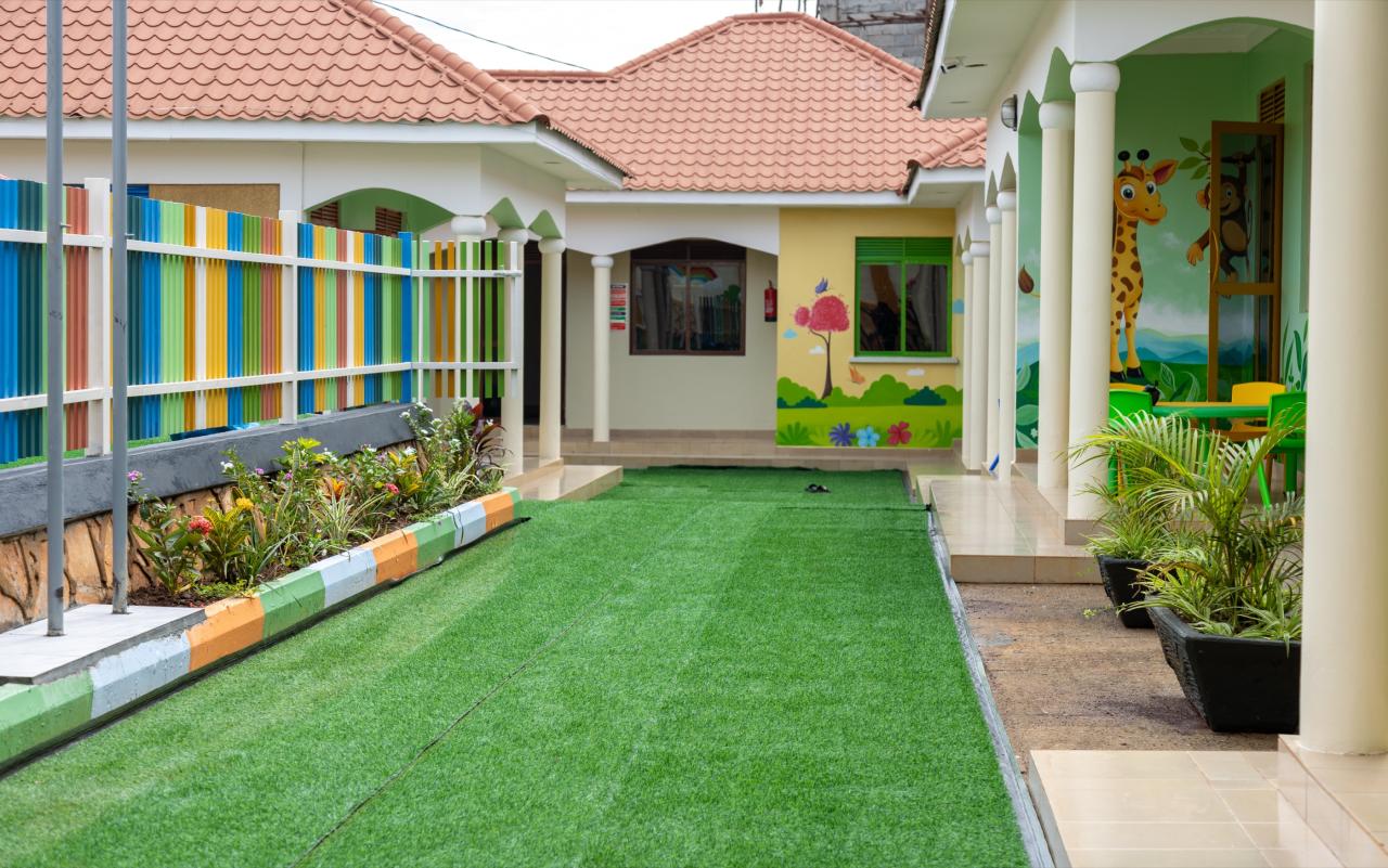 The courtyard lawn with classrooms and a giraffe mural