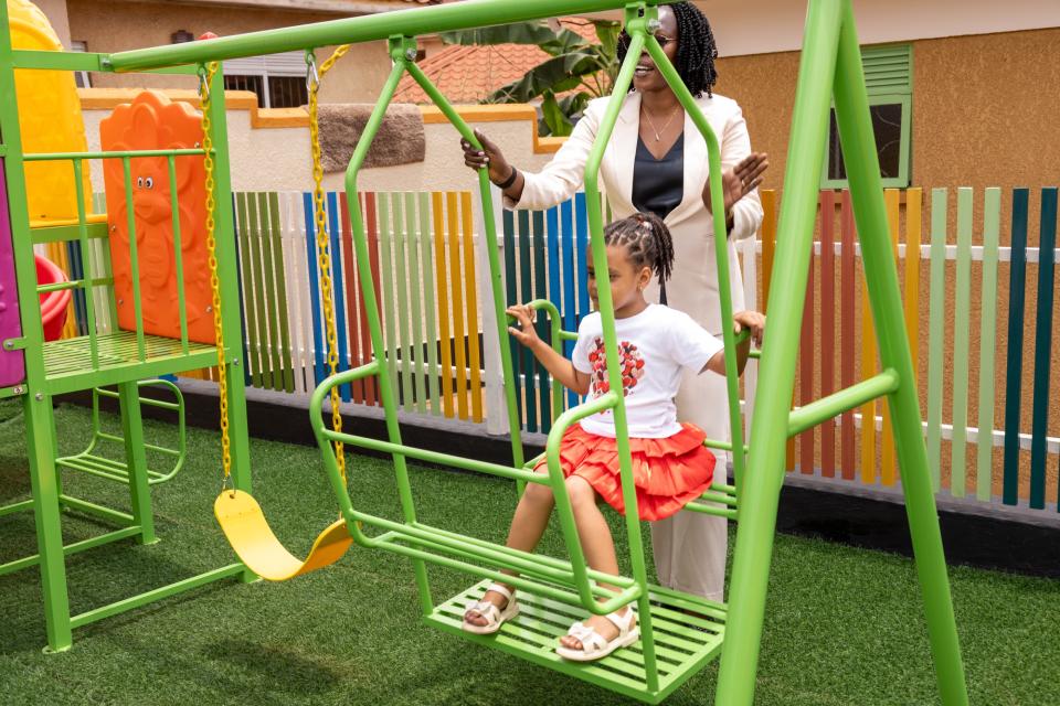 A child playing on the garden swing