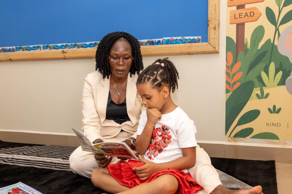 A teacher reading a picture book with a child