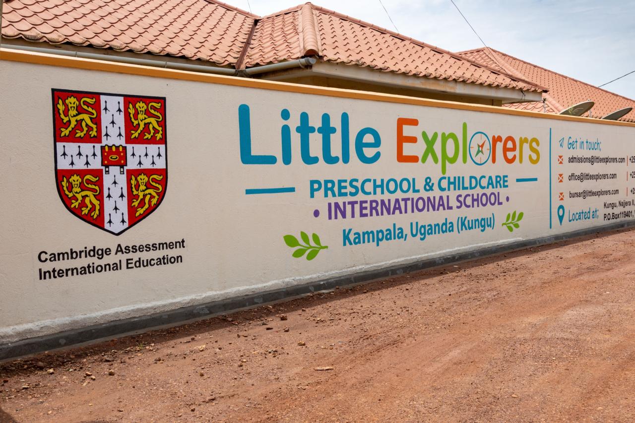 The school wall with the Cambridge crest and Little Explorers sign